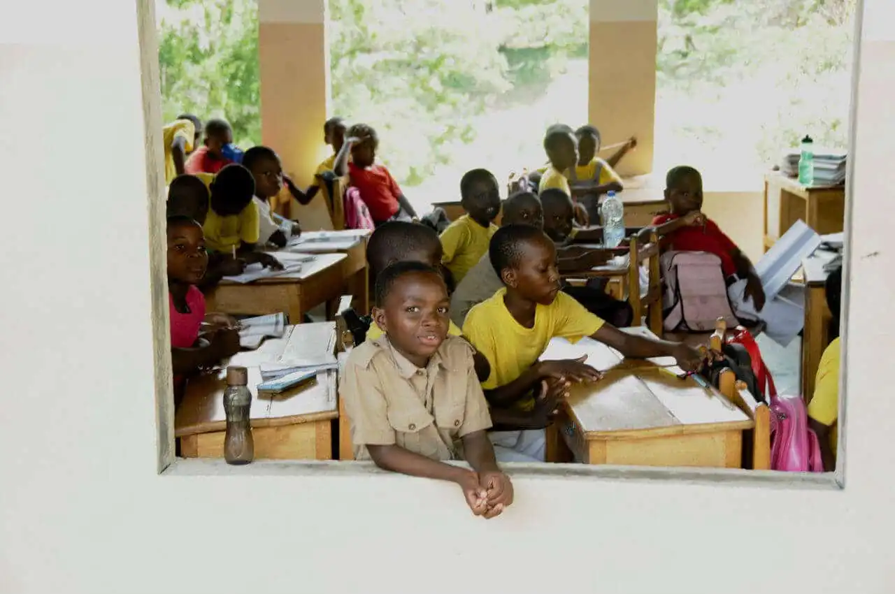 Children in school posing while attending a class