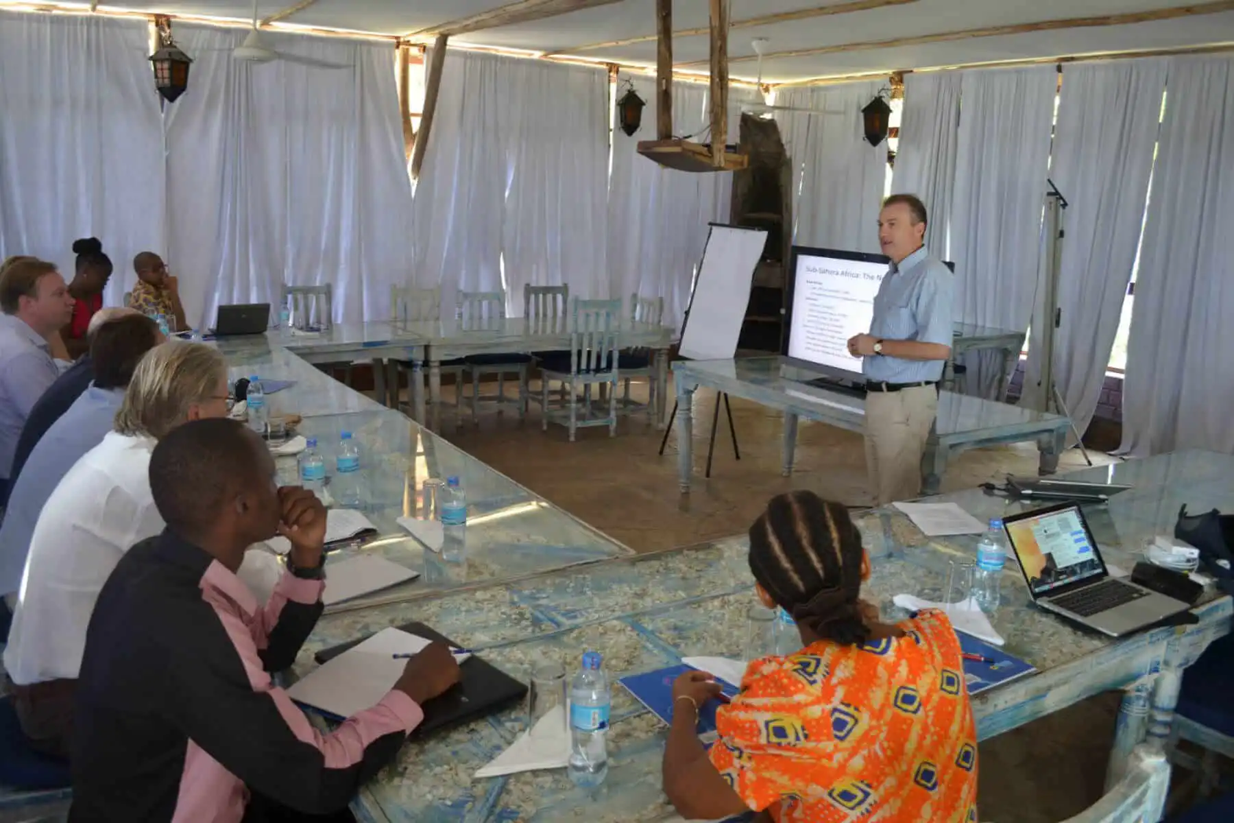MTI investment founder running a meeting in front off African investors