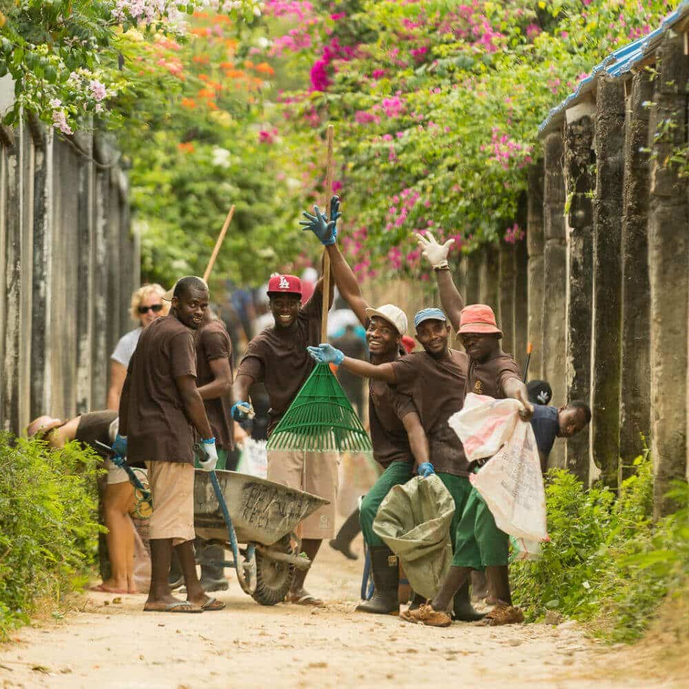 Zanrec worker posing while cleaning & collecting garbage on a beach