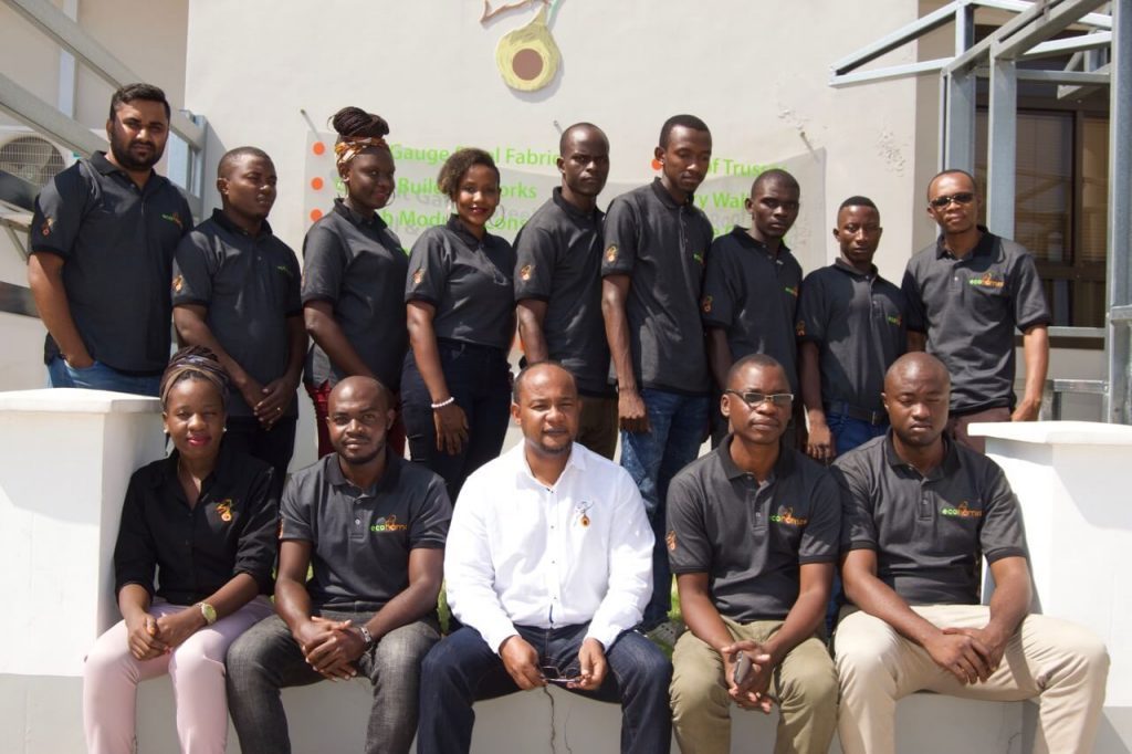 Eco home team posing in front of their building