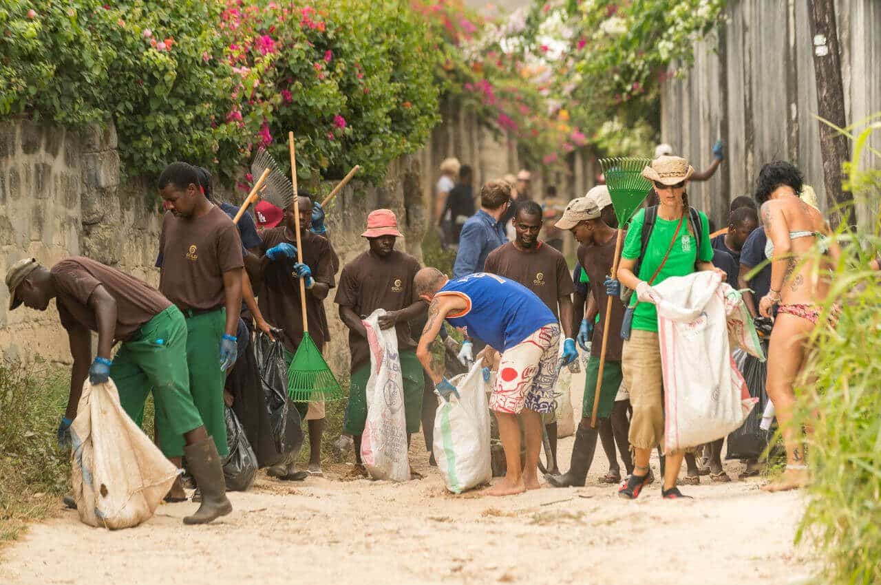 People cleanning and collecting rubbish on a beach