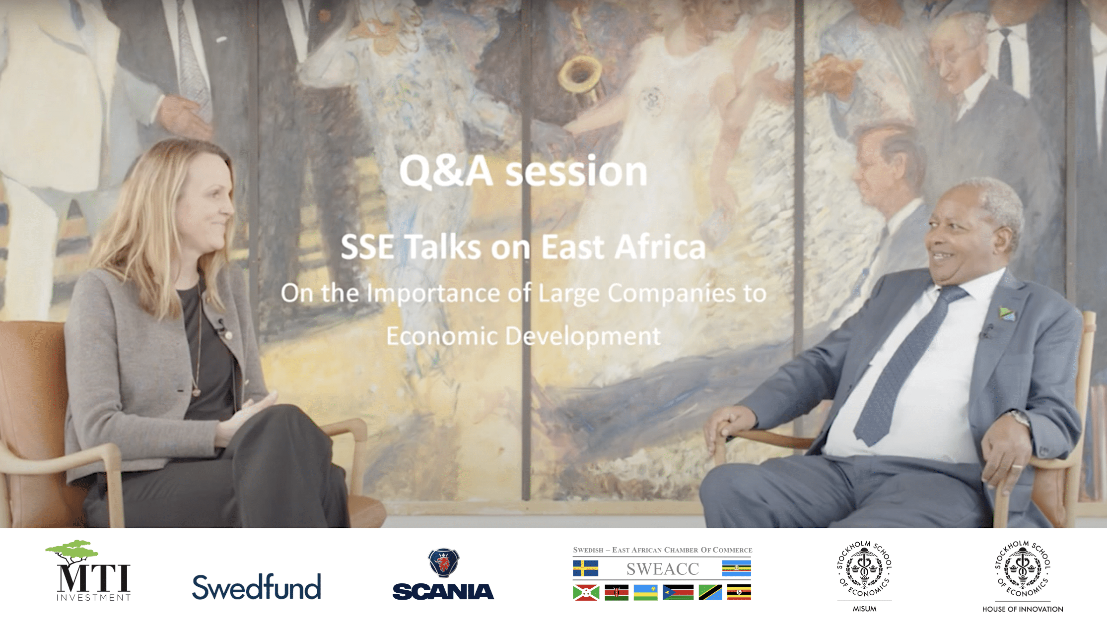 A man and a woman sitting and discuss about the impact of large companies to the economic development in Africa