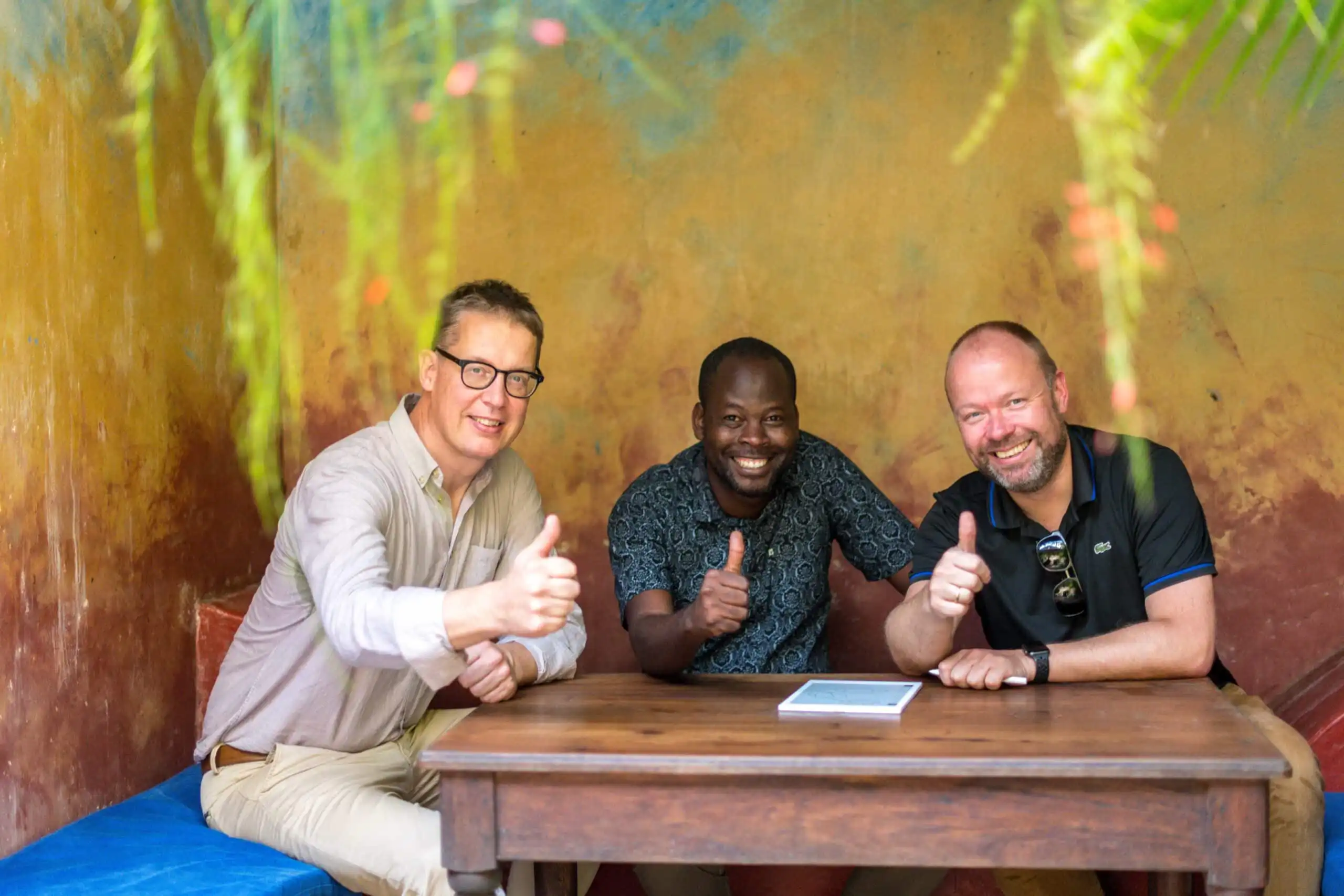 MTI investment team and a client doing a thumb up after signing a contract