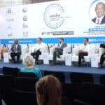 4 men and a woman talk at a tourism investment & travel exibition