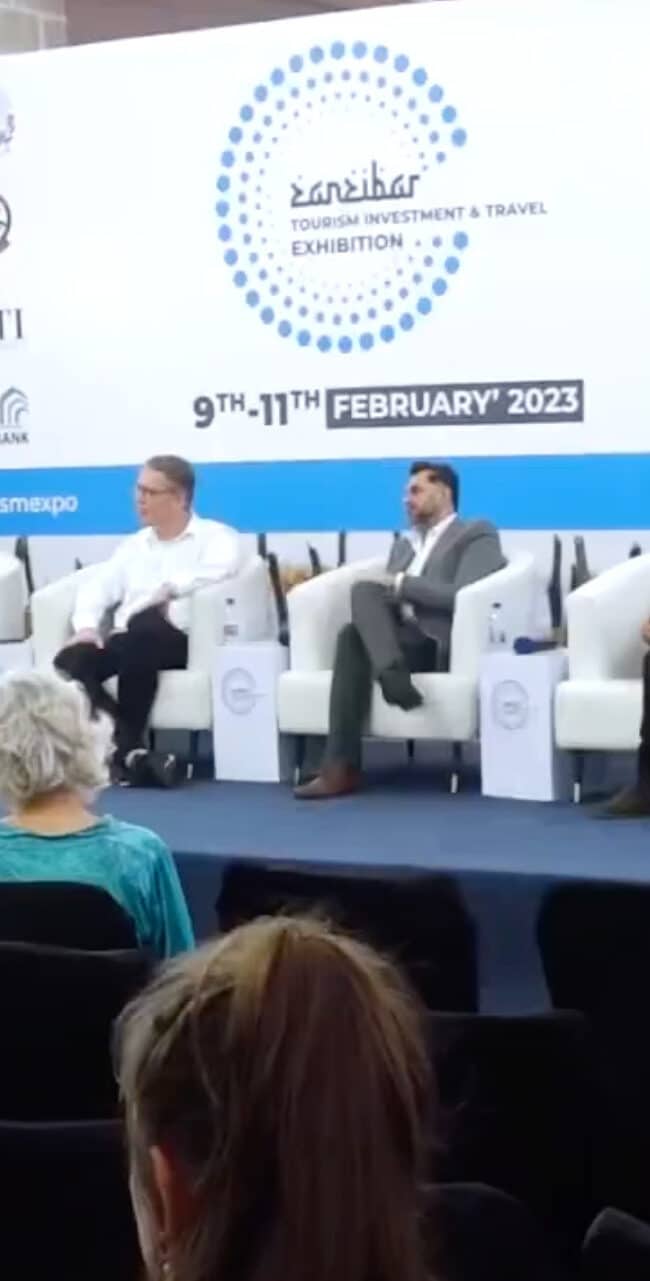 4 men and a woman talk at a tourism investment & travel exibition