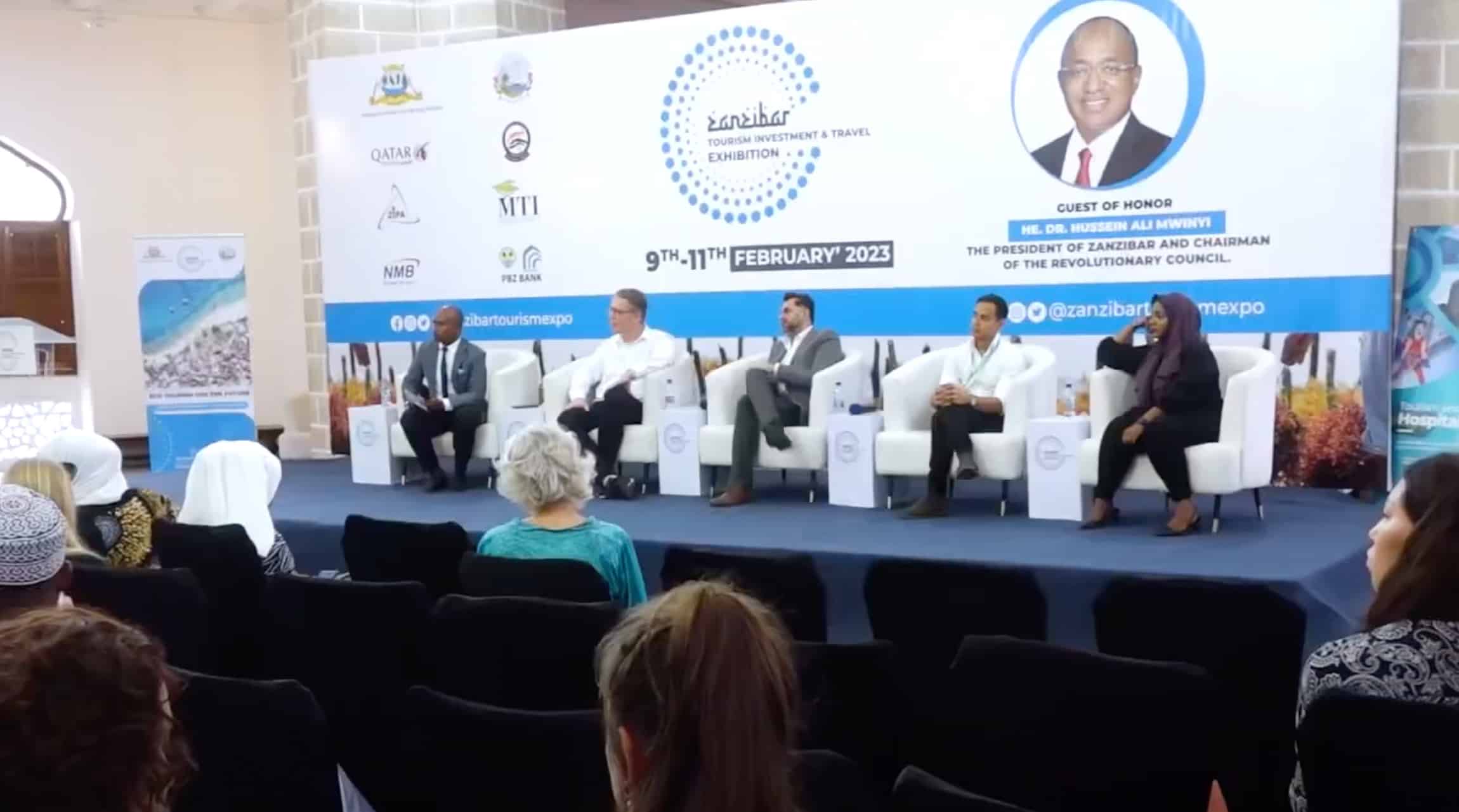 4 men and a woman talk at a tourism investment & travel exibition