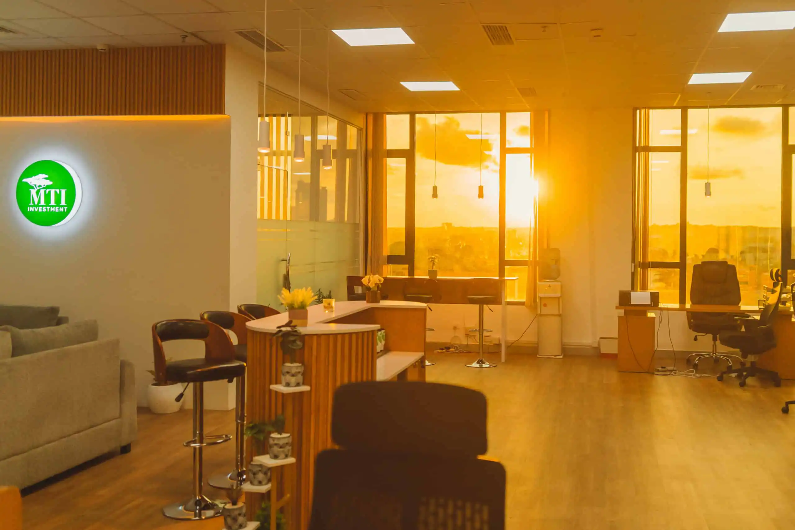 Clean and bright office with a green MTI Investment sign